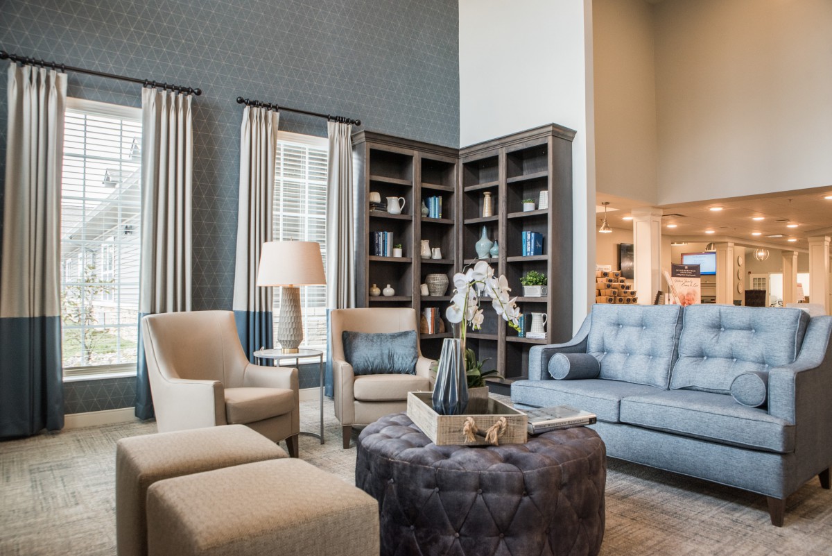 A stylish living room featuring comfortable seating, bookshelves, and tasteful decor.