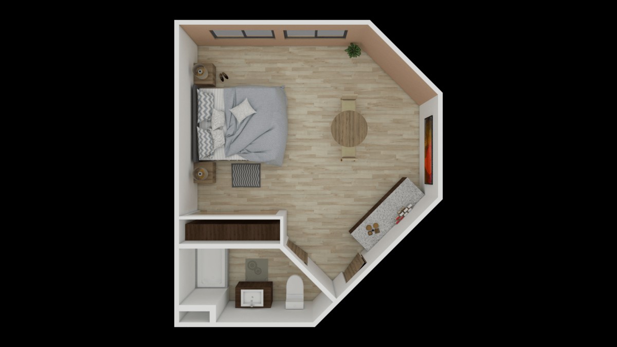 A compact bedroom floor plan featuring a bed, desk, and small bathroom area.