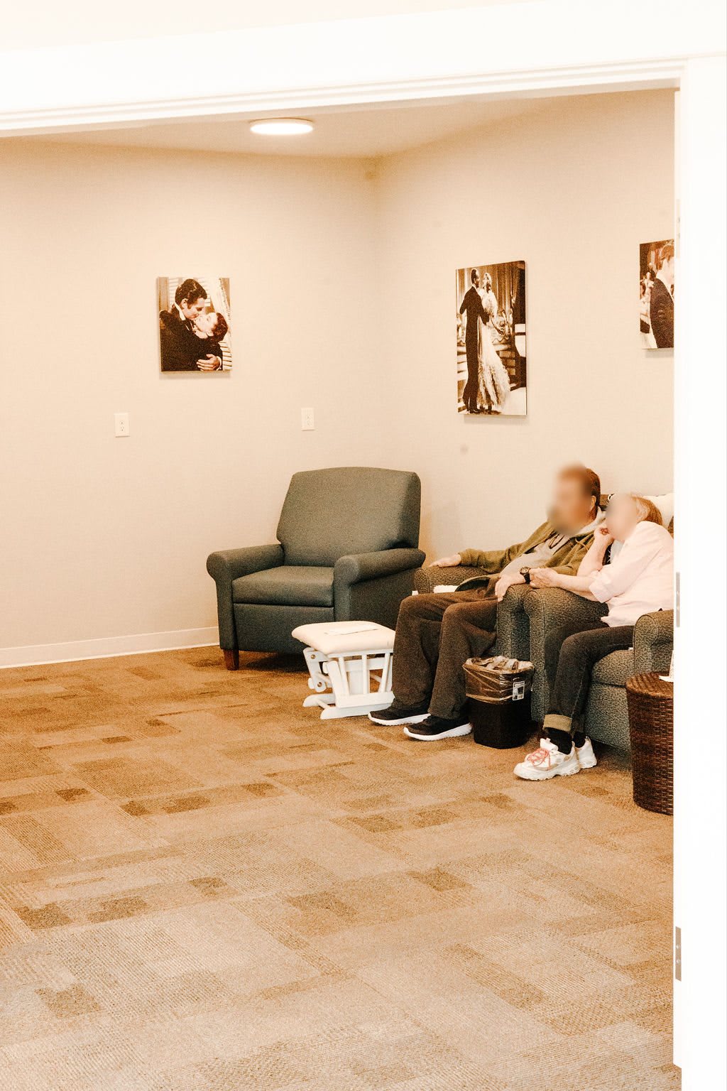 A cozy waiting area with comfortable seating and artwork on the walls.