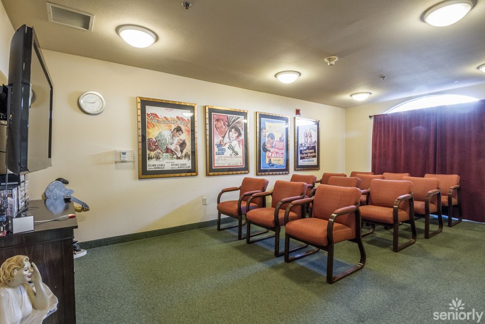 A cozy waiting room with cushioned chairs and framed artwork on the walls.