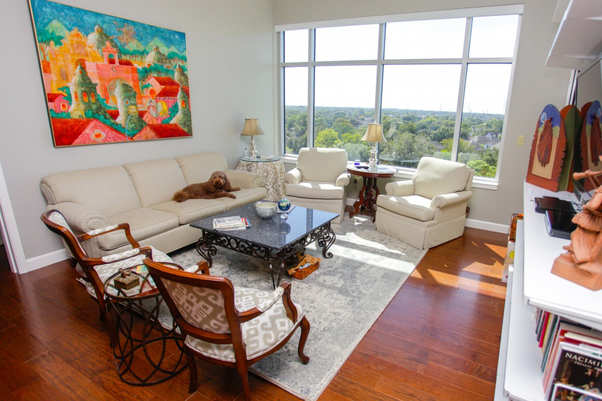 A bright and stylish living room with modern furniture and colorful artwork.