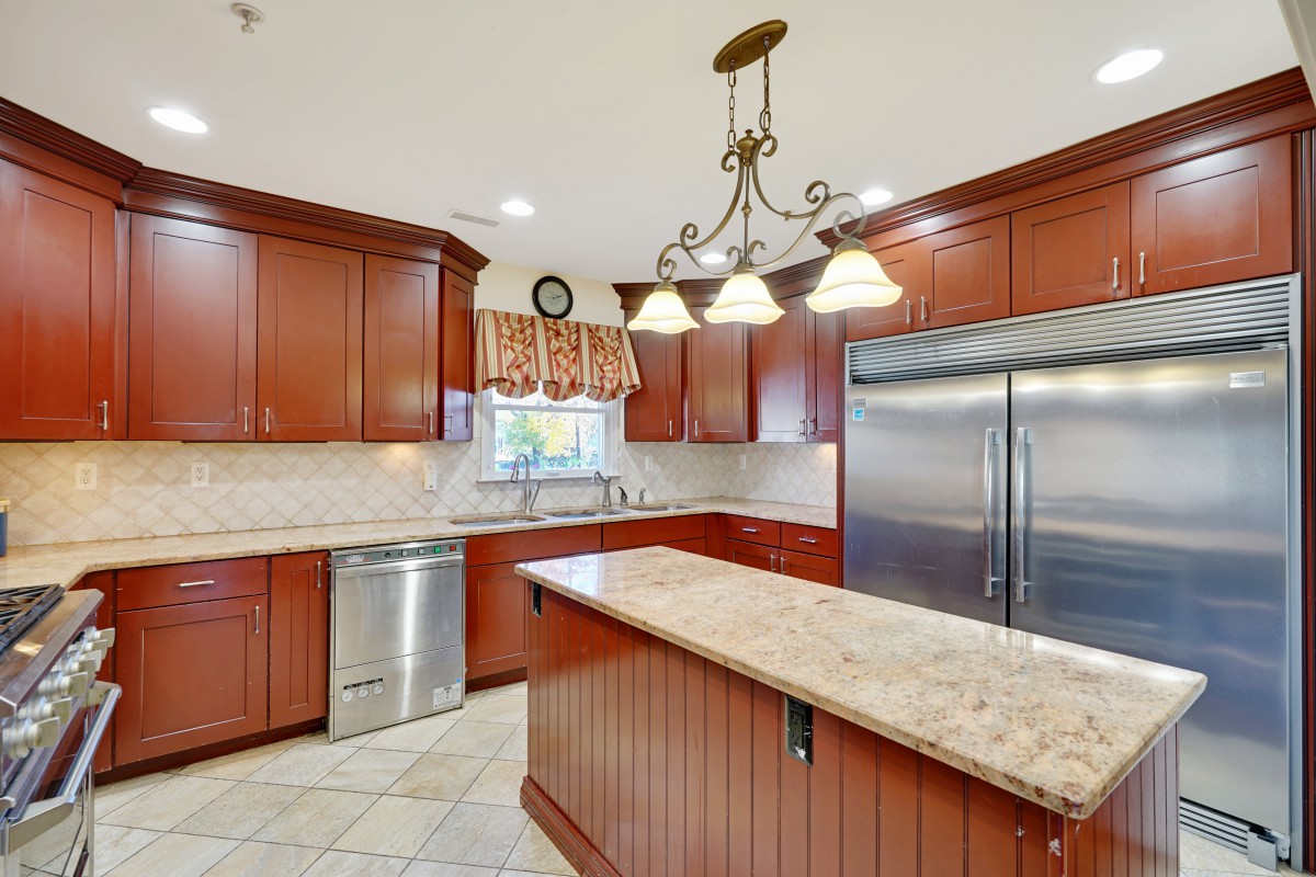 Modern kitchen with wood cabinets and a granite island.
