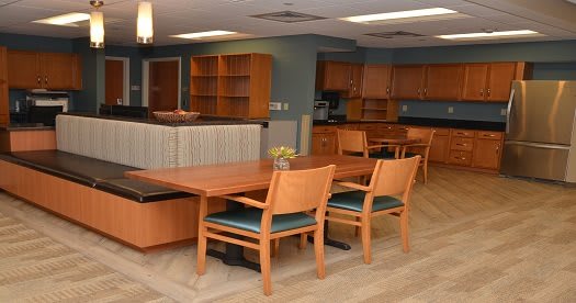 A modern kitchen and dining area with wooden furniture and cabinets.