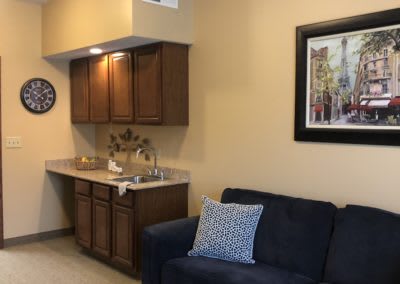 A cozy living space with a small kitchenette and comfortable seating.