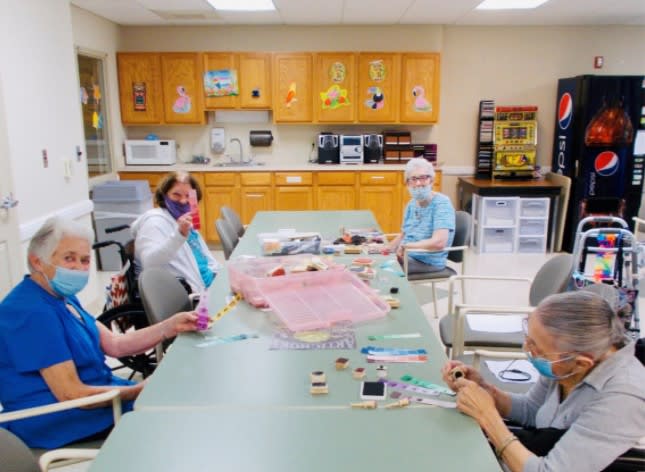 A group of seniors enjoying a crafting session at a community center.