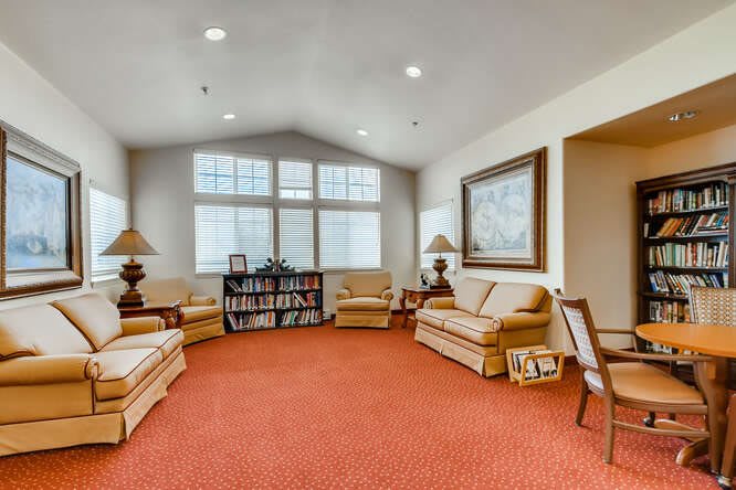 A cozy living room with comfortable seating and warm lighting.