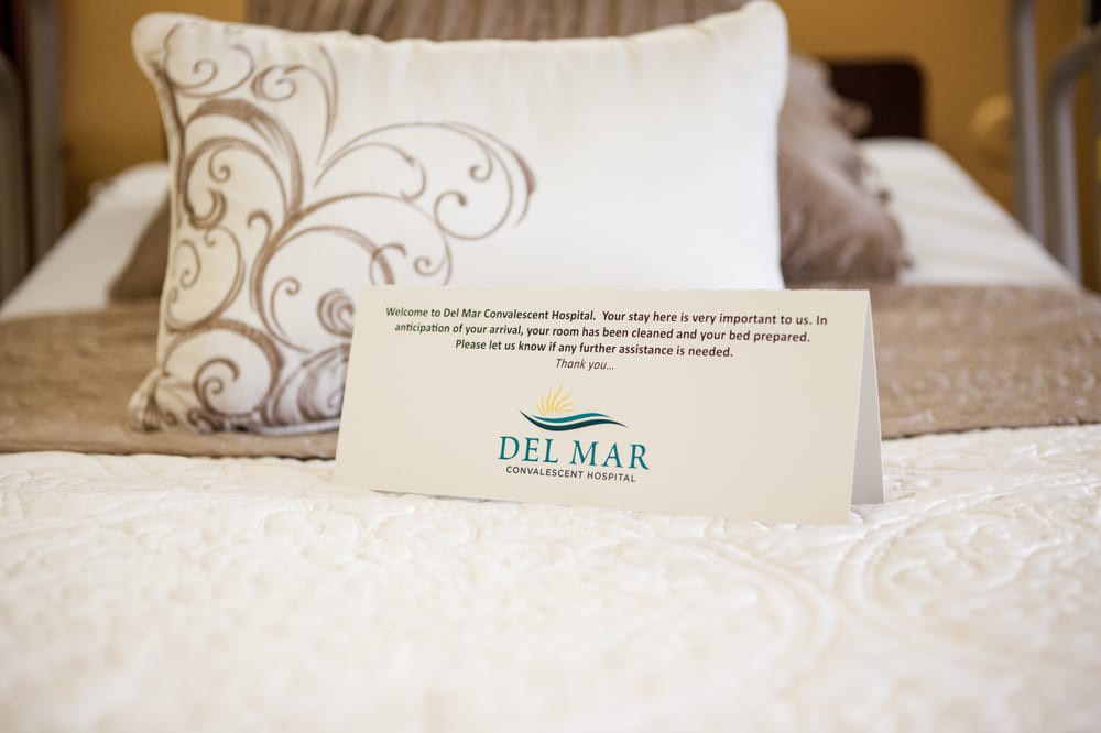 A welcoming note on a bed, showcasing hospitality in a hotel room with stylish decor.