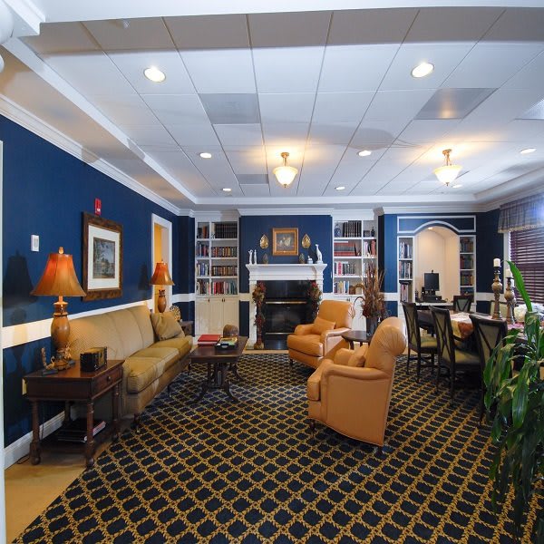A classic living room with blue walls, elegant furniture, and a cozy ambiance.