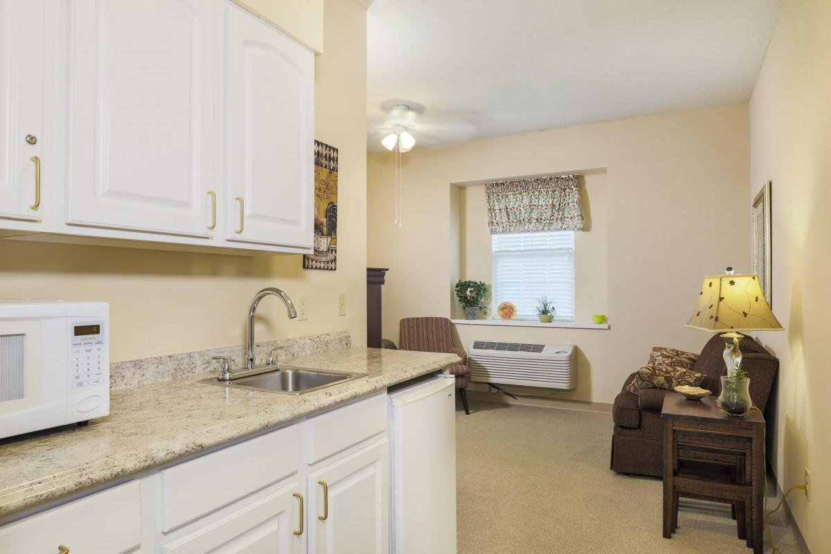 A cozy apartment with an open kitchen and living area.