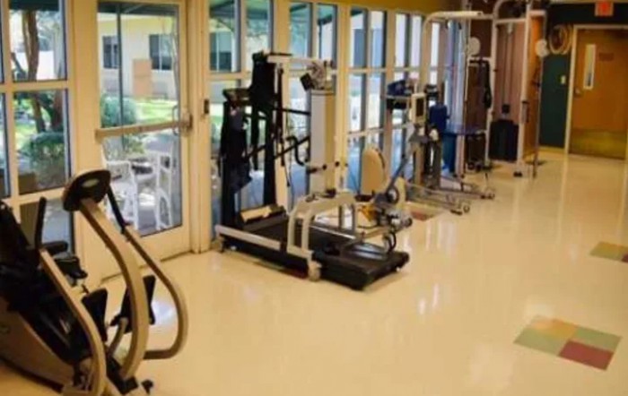 A fitness center with various exercise machines, including treadmills and other workout equipment.