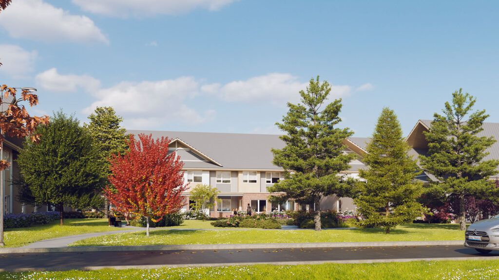 A view of a building surrounded by trees and a well-maintained lawn under a clear blue sky.