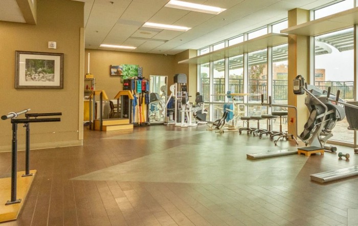 A spacious gym interior with exercise equipment and a well-lit training area.