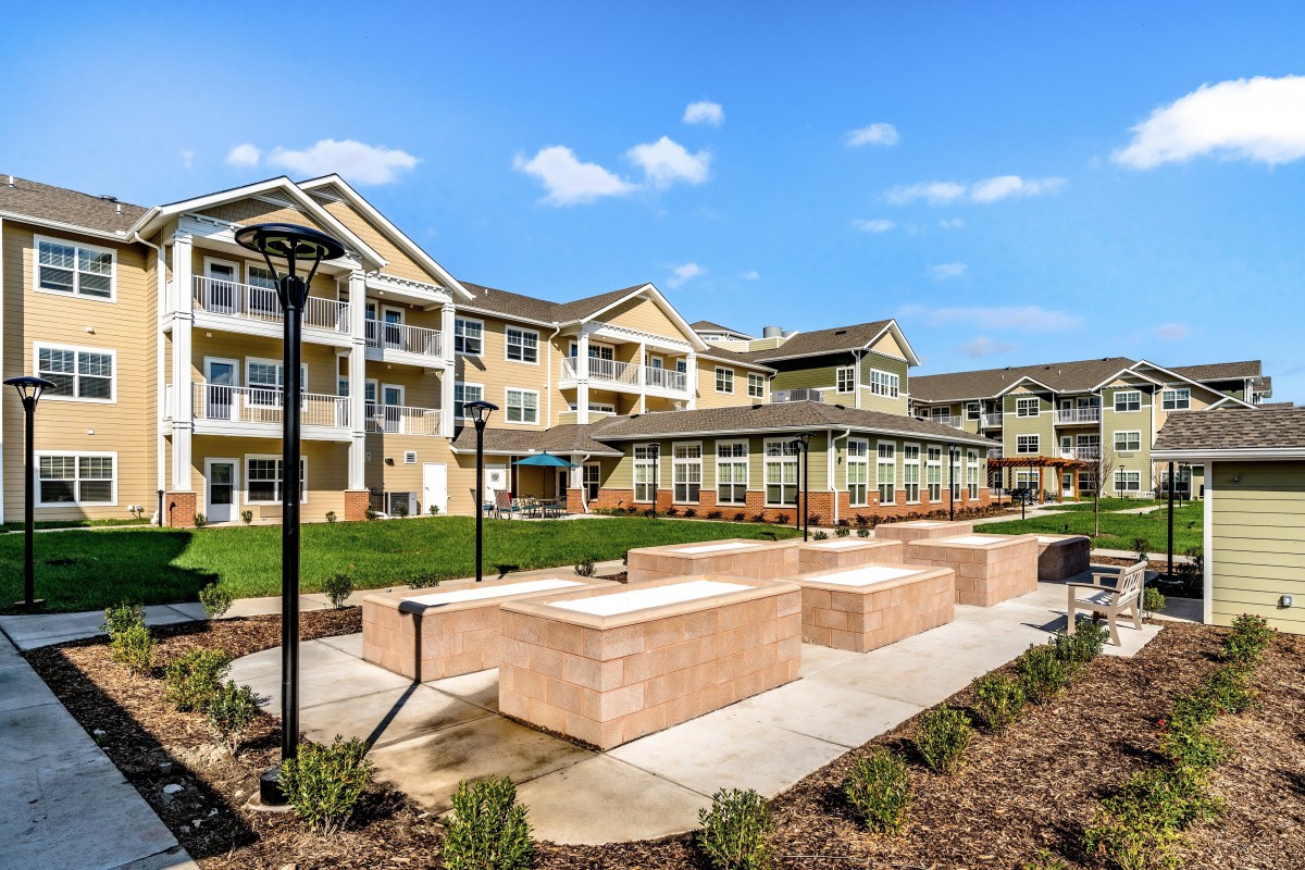 A modern residential apartment complex with landscaped outdoor spaces.