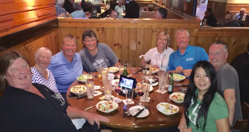 A cheerful gathering of friends enjoying a meal together at a restaurant.