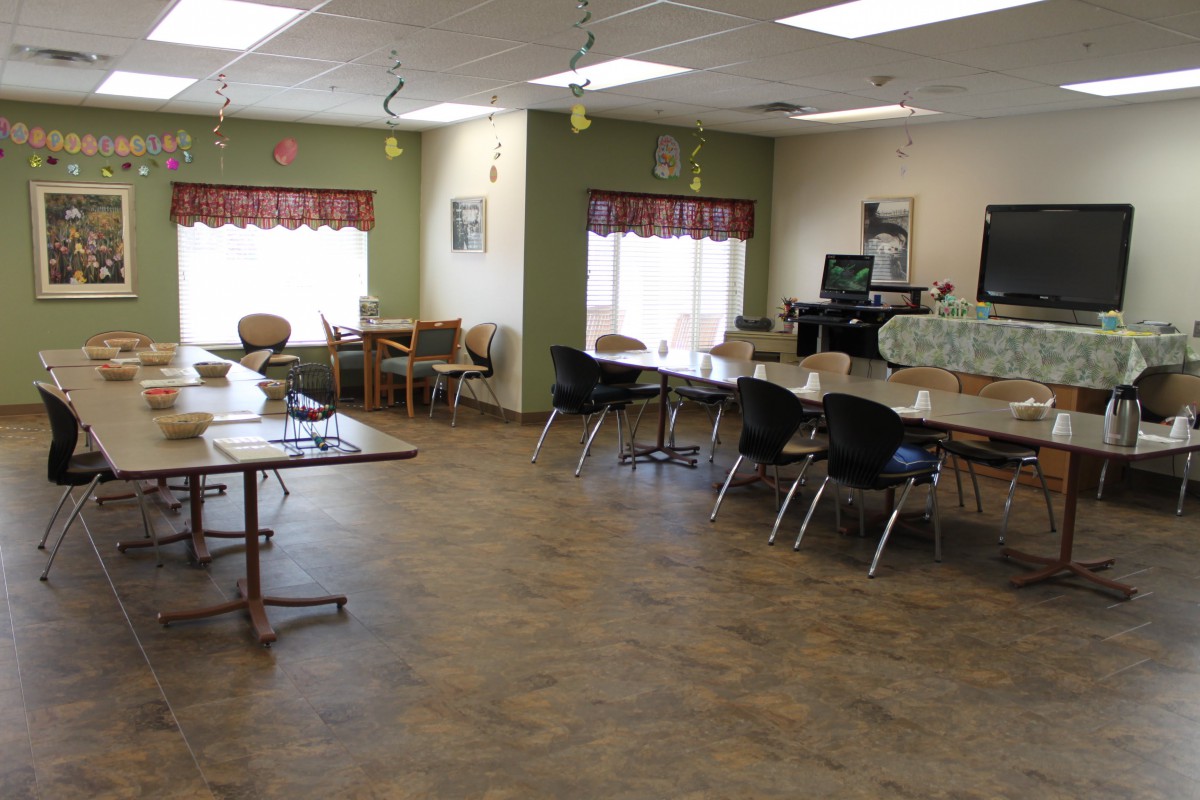 A spacious dining area with tables and chairs arranged neatly.