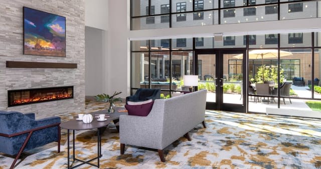 Modern lobby interior with a comfortable sofa and large windows.