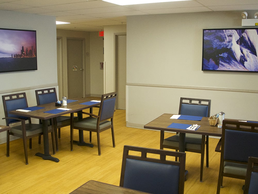 An empty indoor dining area with neatly arranged tables and chairs.