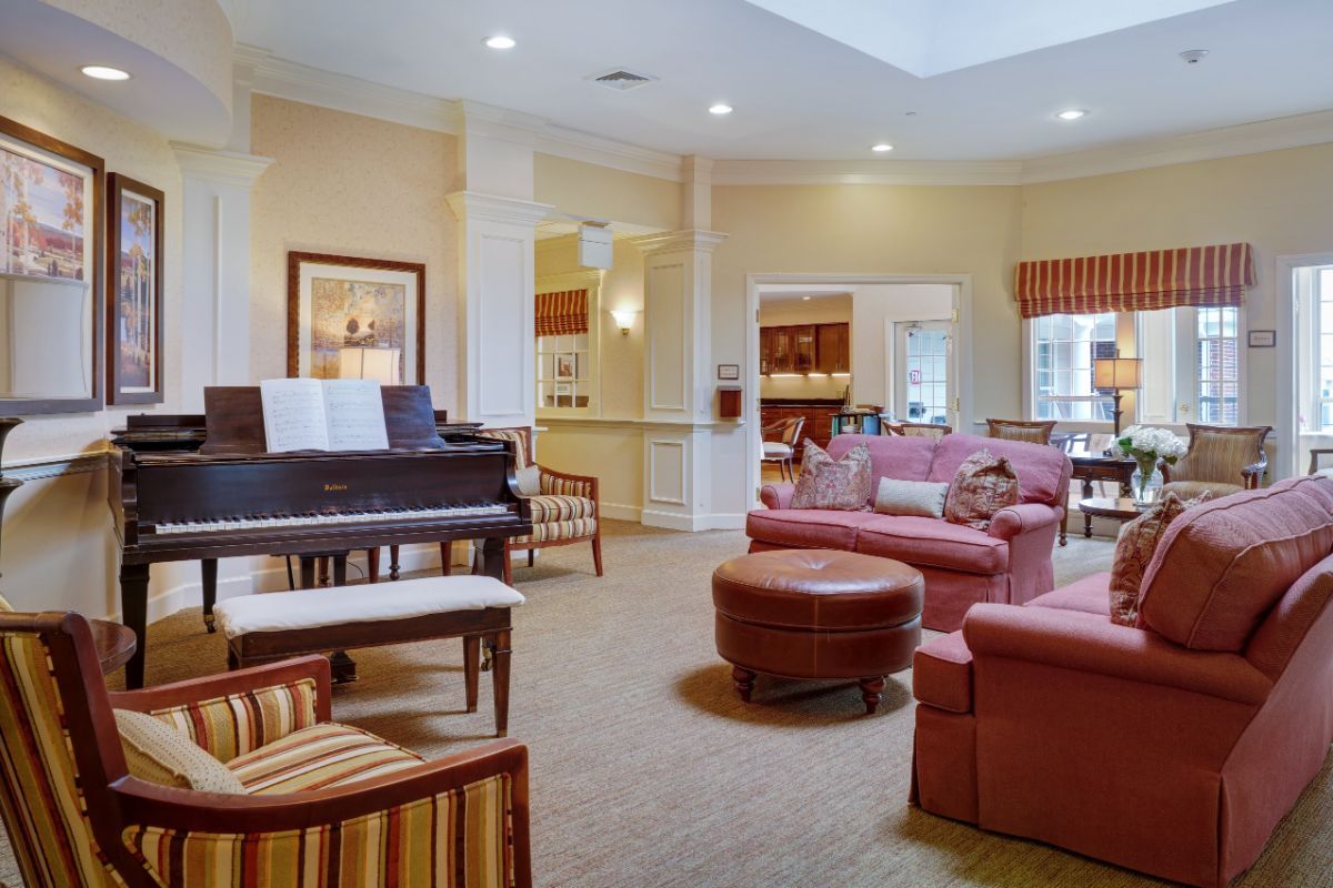 A cozy lounge area with comfortable seating and a piano.