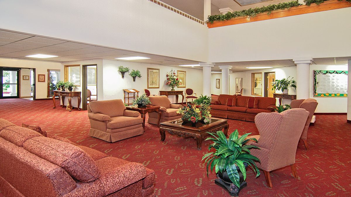 A spacious lobby with comfortable seating and plants.