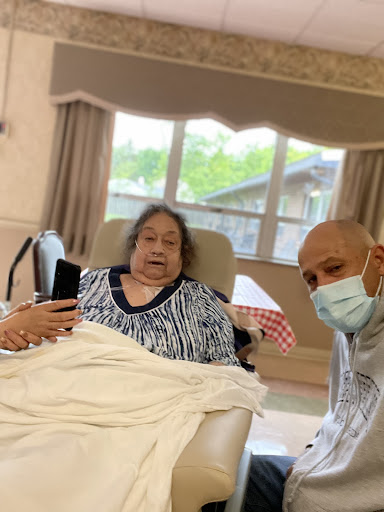A caregiver takes a moment to connect with a patient in a healthcare setting.