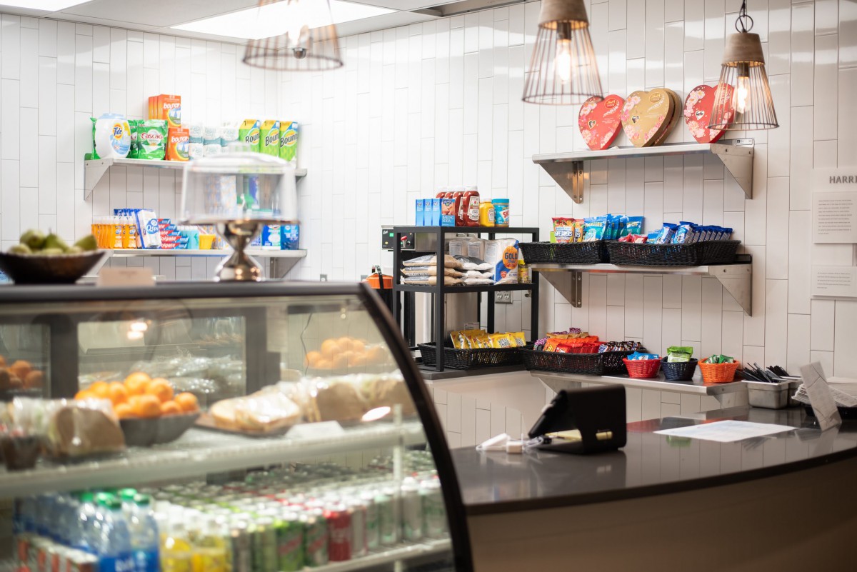 An inviting cafe counter displaying a variety of snacks and beverages.