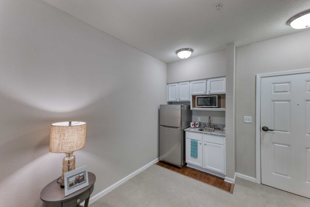 A compact, modern kitchen space in an apartment with minimalist design.