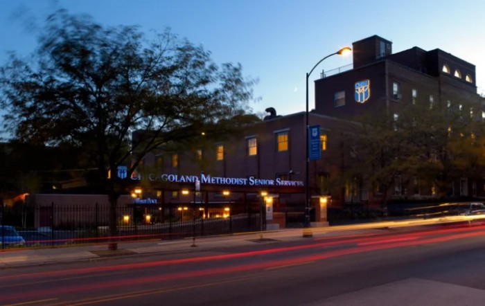 A cozy restaurant illuminated by street lights in the evening.