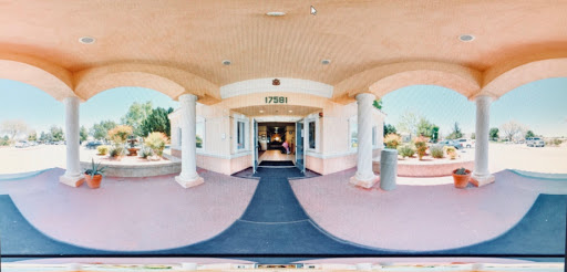 A welcoming entrance to a building with a well-maintained path and inviting atmosphere.