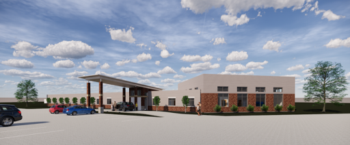 A modern building with a welcoming entrance and clear blue skies.