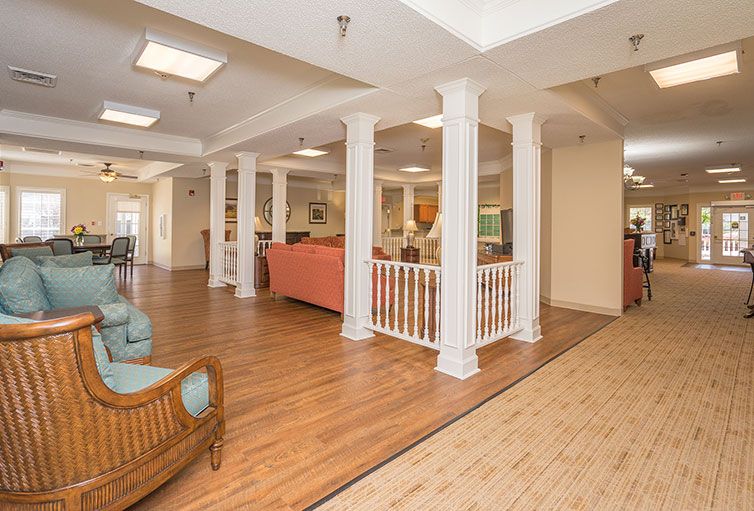 A spacious living area with comfortable seating and elegant pillars.