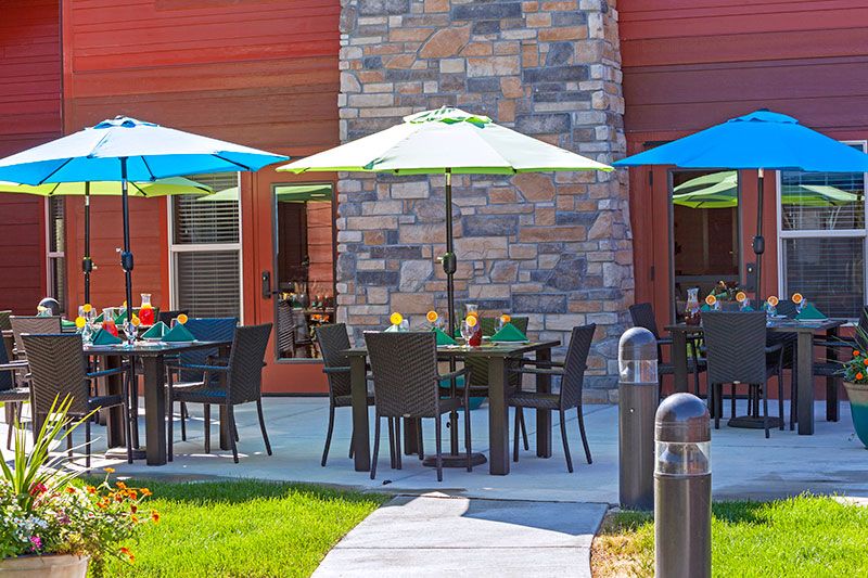 An inviting outdoor dining area with tables and colorful umbrellas.