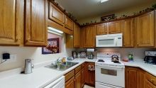 A cozy kitchen with wooden cabinets and modern appliances.