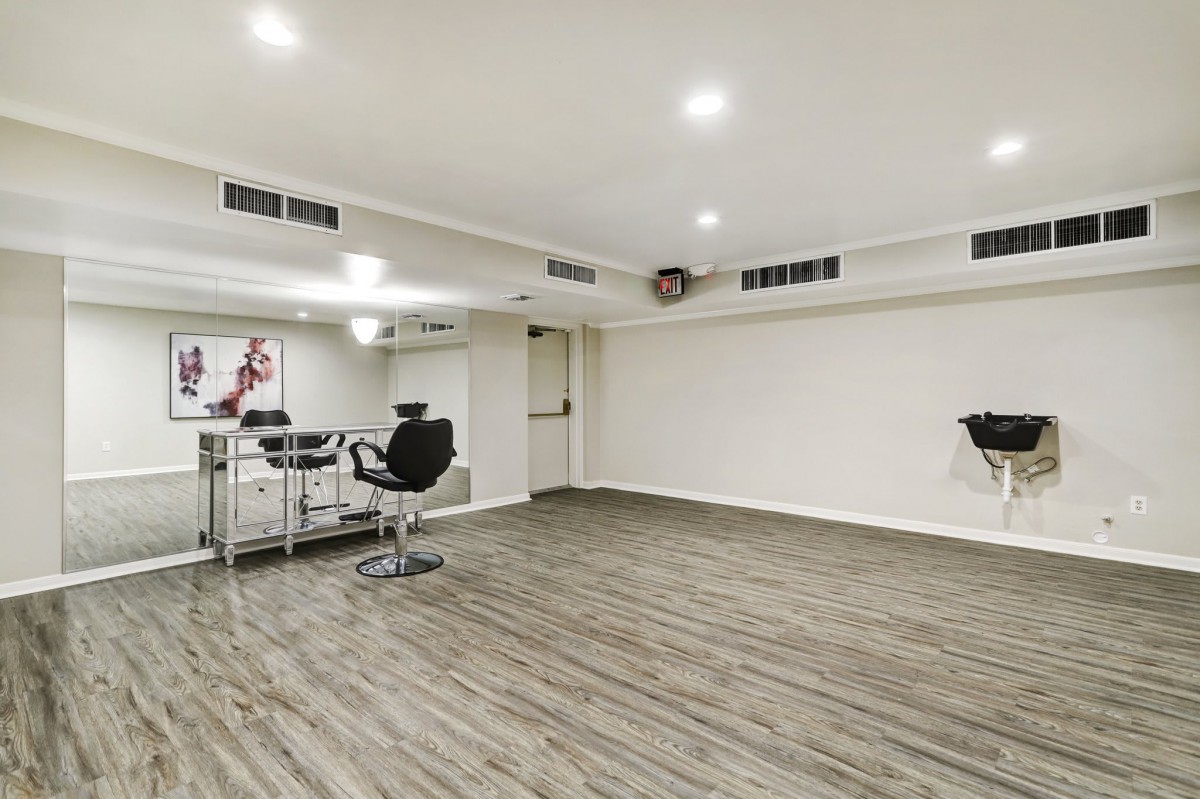 A modern and minimalist office space with sleek flooring and simple furniture.