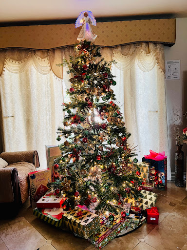 A beautifully decorated Christmas tree surrounded by colorful presents, creating a festive atmosphere.