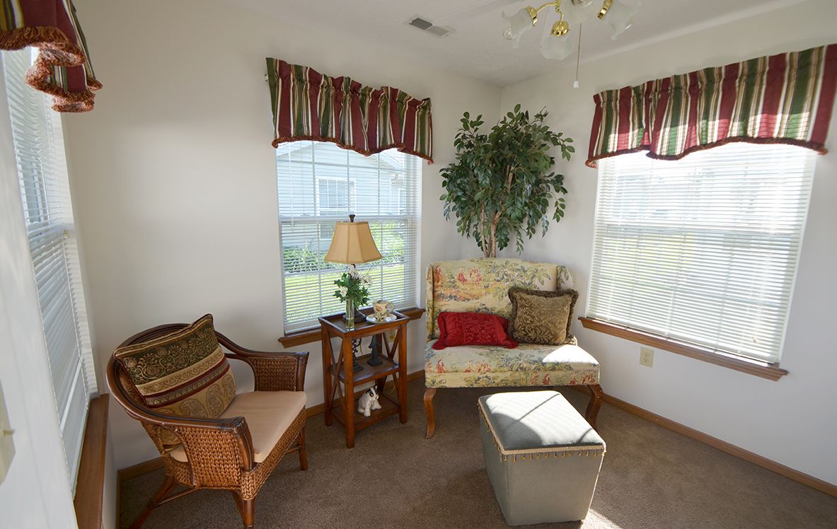 A cozy living room corner with comfortable seating and plenty of natural light.