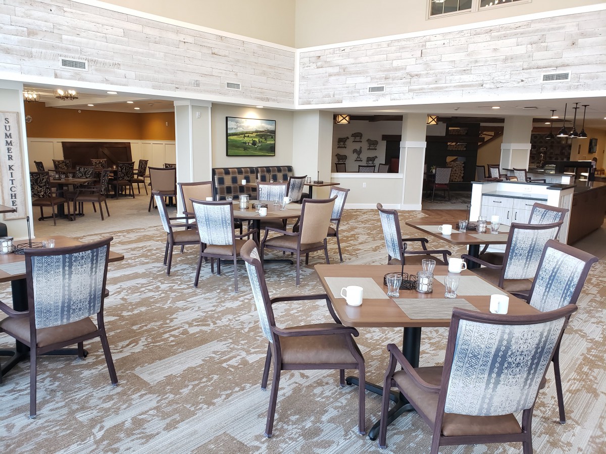A modern restaurant dining area with neatly arranged tables and chairs.