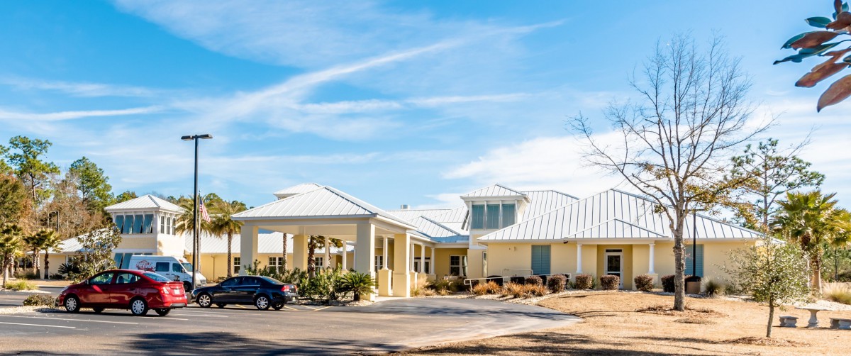 A single-story house with a driveway and clear blue sky.