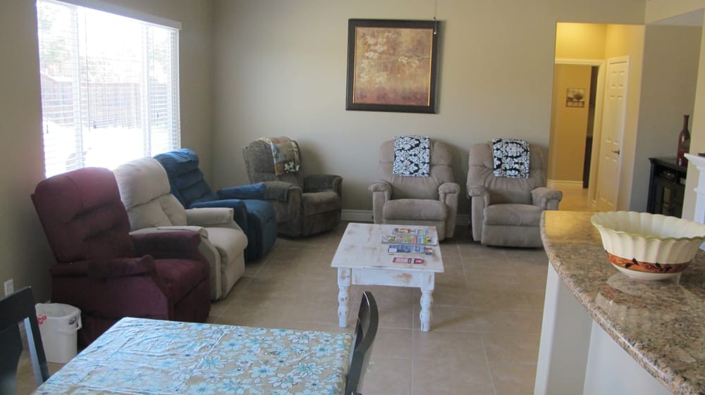 A cozy living room with multiple armchairs and a central coffee table.