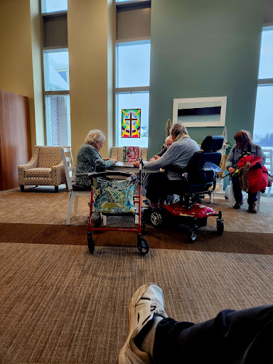 A group of elderly individuals engaging in a social activity at a community center.