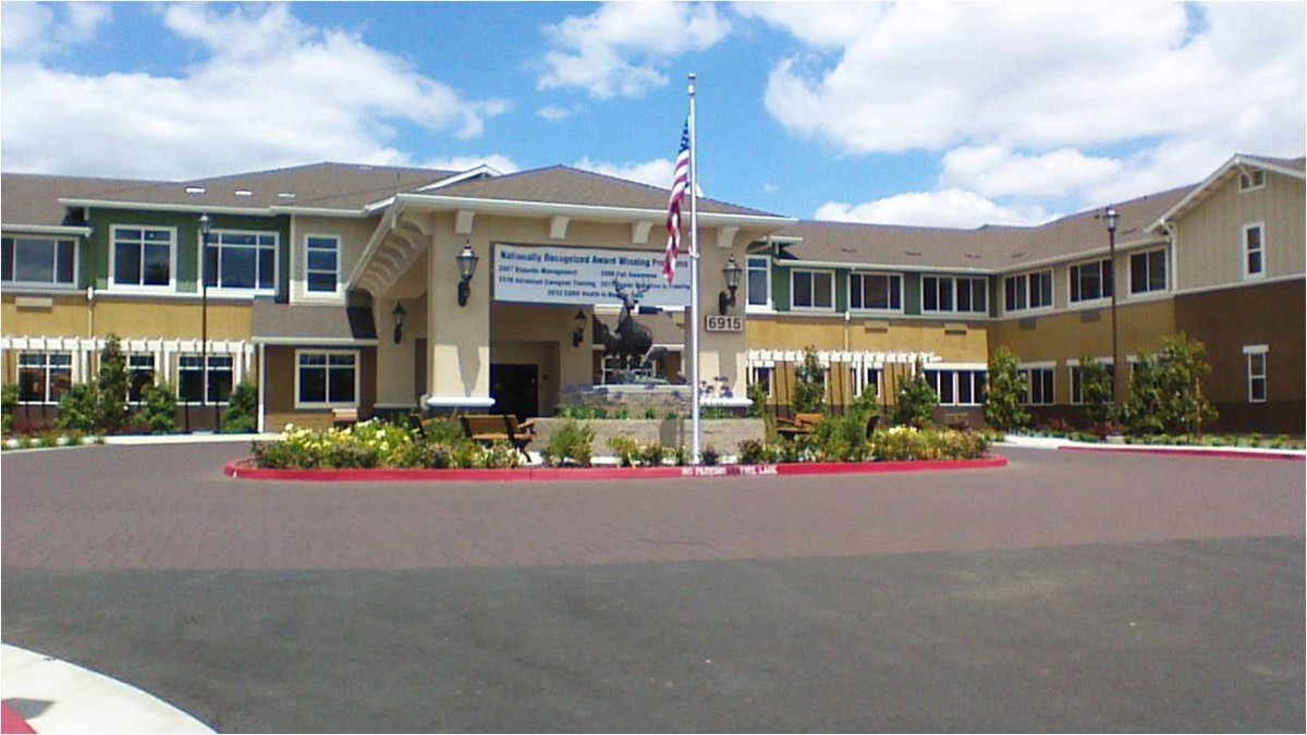 A residential building with an American flag at the entrance.