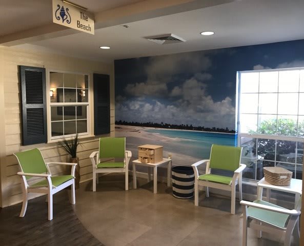 A cozy waiting room with beach-themed decor and comfortable seating.