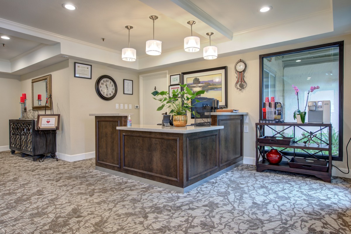 A welcoming reception area with a wooden desk and elegant decor.