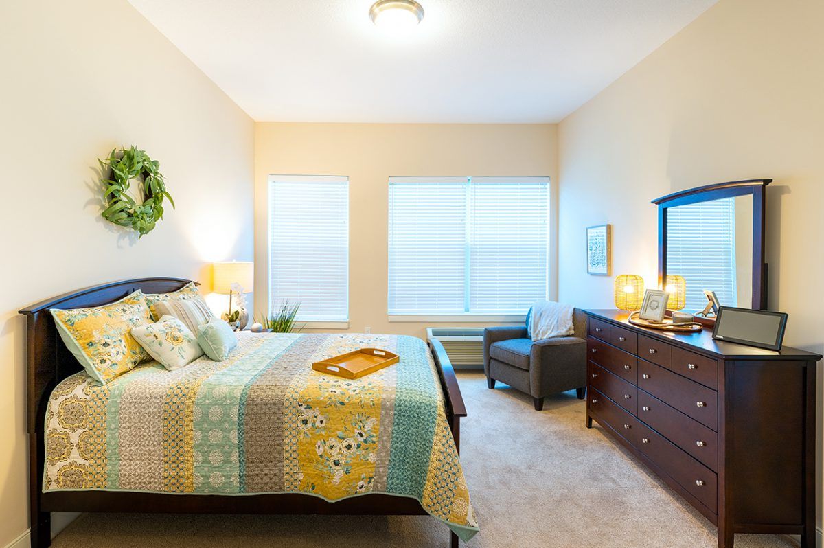 A cozy bedroom with a colorful quilt and stylish decor.