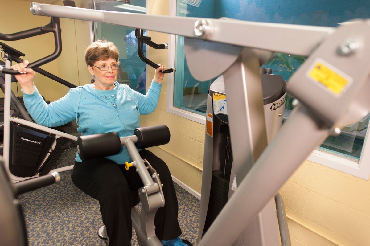 A person working out on fitness equipment at the gym.