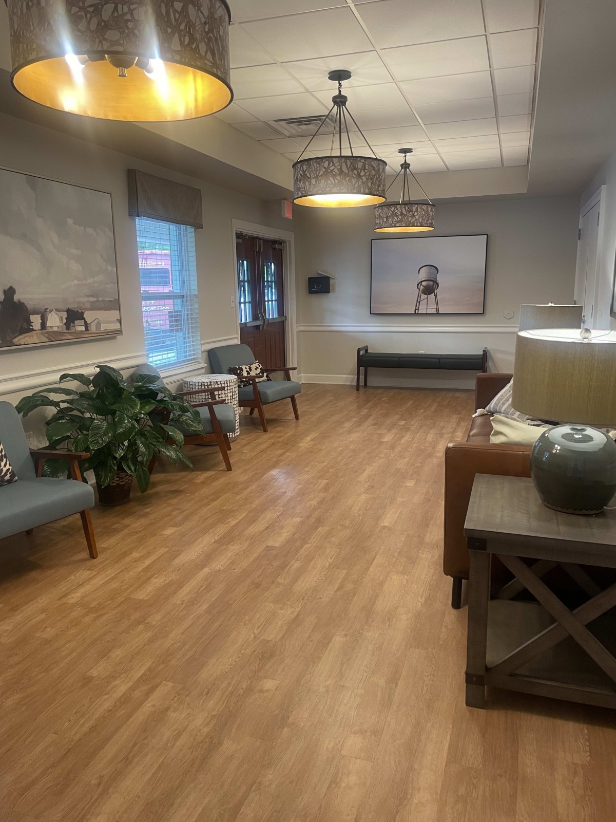 A cozy waiting room with comfortable seating and decorative artwork.