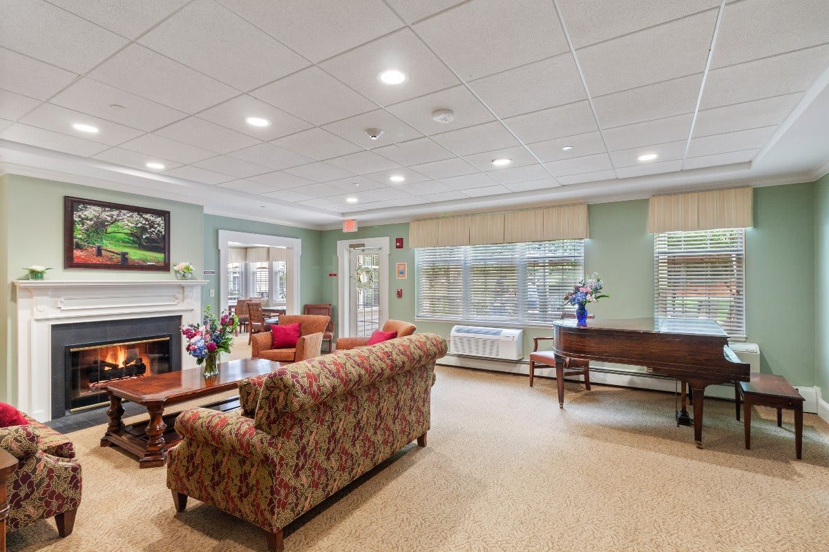 A cozy and well-decorated living room with comfortable seating, a coffee table, and a fireplace.