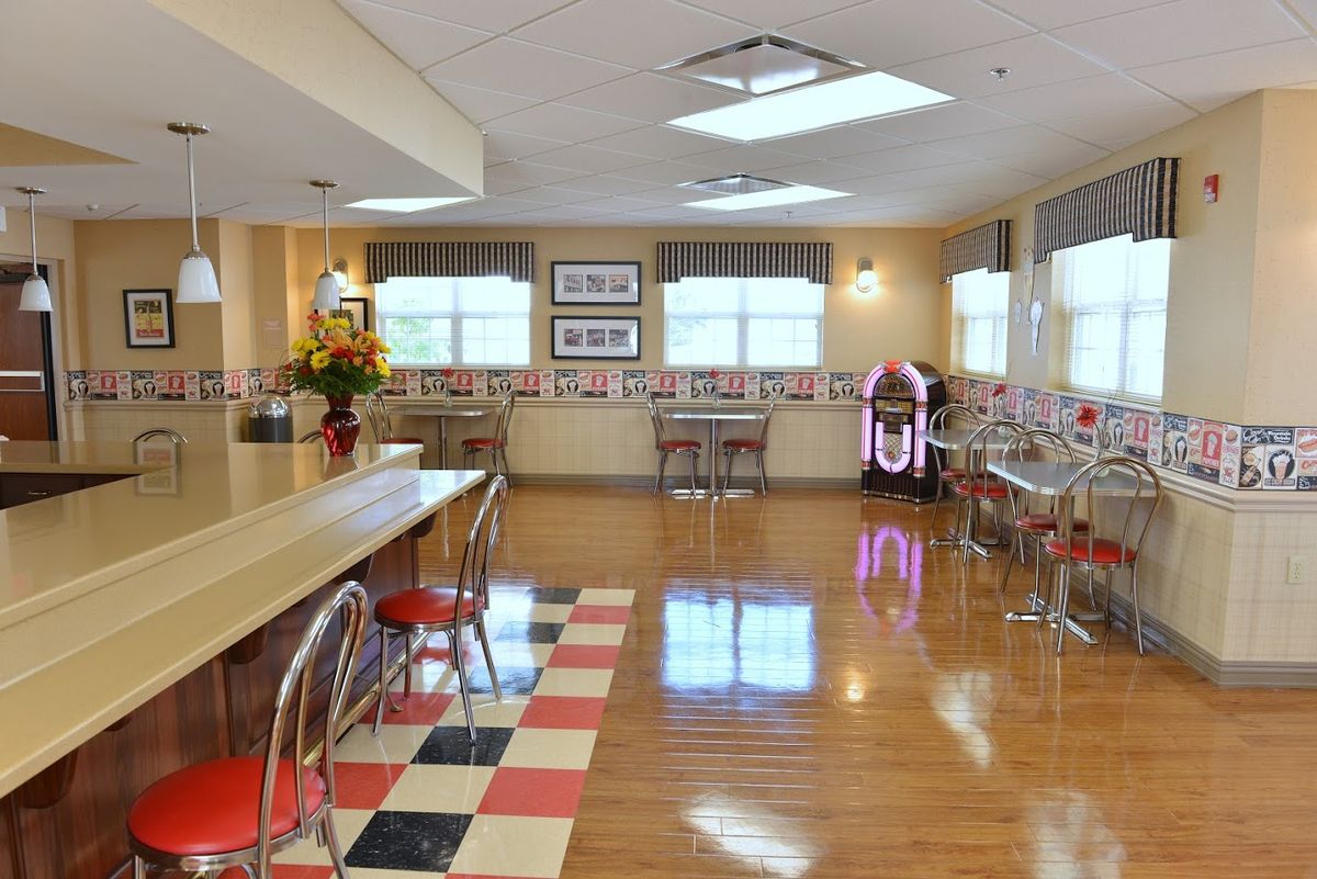 A retro diner interior with a jukebox and checkered floor.