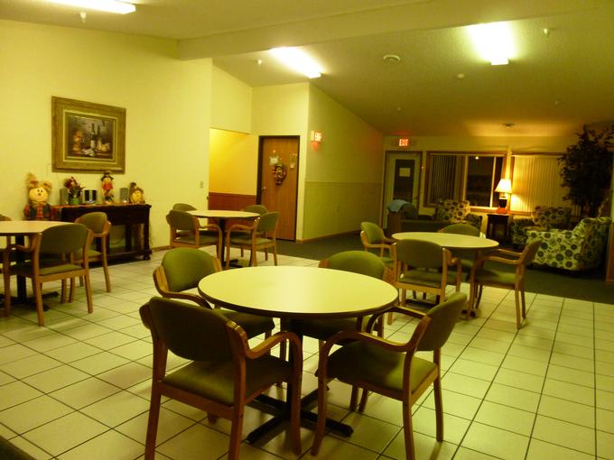 An indoor seating area with tables and chairs.