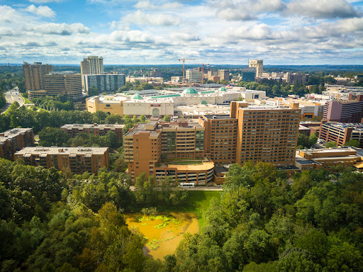 A panoramic view of a bustling urban landscape under a partly cloudy sky.