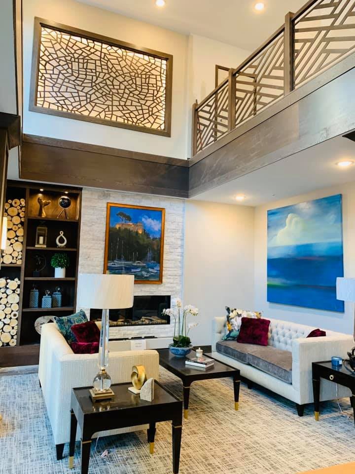 A modern, luxurious living room featuring contemporary furniture and vibrant artwork.